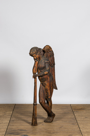 A large wooden relief with an angel resting on his trumpet, 18th C.