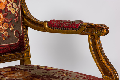 A neoclassical gilt wooden salon set comprising a sofa and four armchairs, 20th C.