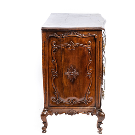 A French Louis XV-style walnut chest of drawers, 19th C.