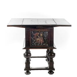 A rare ebonised wooden baluster leg table with polychromed reliefs, 17th C. with later elements