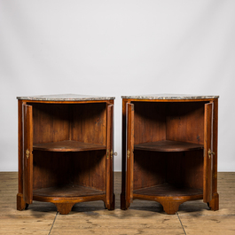 A pair of French mahogany corner cabinets with marble tops, 18/19th C.