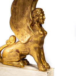 An Italian gilt and patinated wooden table with a marble top resting on three sphinxes, 19th C.