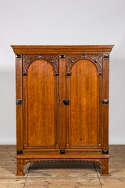 A Dutch oak two-door cupboard with ebonised elements, 17th C.