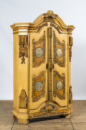 A German patinated wooden two-door cabinet with relief design and monogram R.K., 19th C.