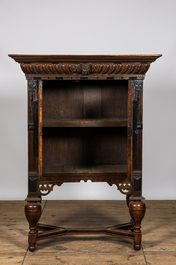 An oak and partly ebonised wooden two-door cupboard on foot, 19th C.