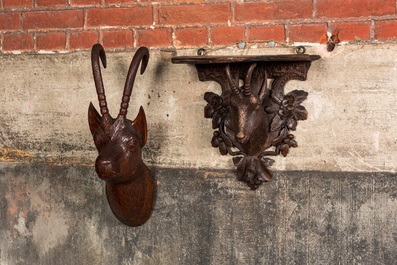 A carved wooden 'Black Forest' goat's head console and a carved oak head of a buck, Switzerland and/or Germany, 19/20th C.