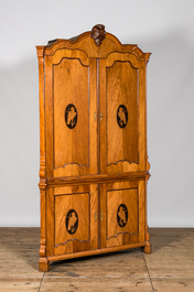 A fruit wood corner cabinet with marquetry design of parrots in medallions, last third 18th C.