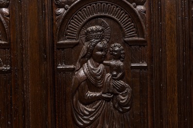 A carved oak panel with saints mounted as a heating frame, 19/20th C.