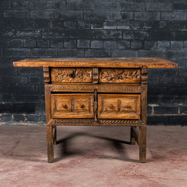 A Spanish carved wooden table with four drawers, 17th C. and/or later