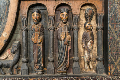 A Spanish polychrome wooden panel depicting Jesus in a medallion surrounded by the twelve apostles after the altar of Sant Pere in Ripoll, 19th C.