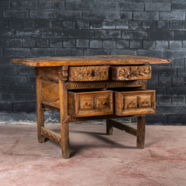 A Spanish carved wooden table with four drawers, 17th C. and/or later