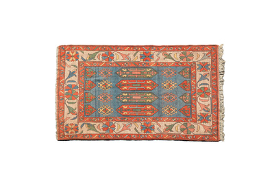 An Oriental woolen rug with floral design and geometric motifs, 20th C.
