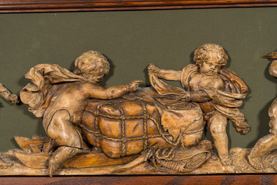 An exceptionally long carved wooden frieze with allegorical depictions of putti, 18th C.