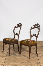 A pair of 'Black Forest' wooden chairs with embroidered upholstery, ca. 1900