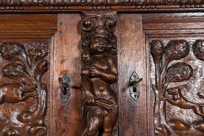 A Flemish richly carved oak 'beeldenkast' or cupboard, 17th C.