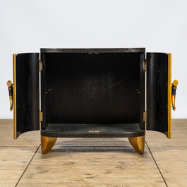 A curved black and gilt lacquered wooden two-door cabinet, 20th C.