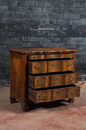 A French Louis XV-style oak commode on lion paw stands, 19th C.