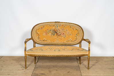 A French five-piece gilt wooden salon set comprising a sofa and four armchairs with embroidered upholstery, 19th C.