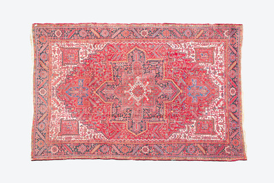 A Persian Heriz rug with floral design and geometric motifs, wool on cotton, 20th C.