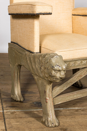 A gray patinated wooden armchair with lion heads, 20th C.