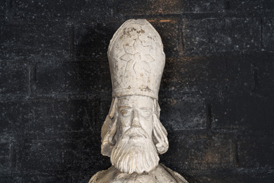 A large limestone sculpture of a standing bishop, 18th C.