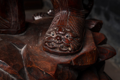 A large Chinese carved wooden group with a warrior and a child, 20th C.