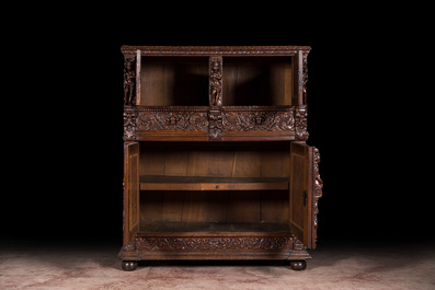 A Flemish richly carved oak 'beeldenkast' or cupboard, 17th C.