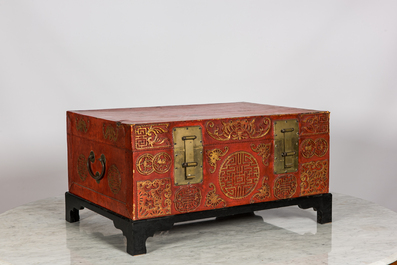 A Chinese red lacquered bronze-mounted travel trunk on foot, 20th C