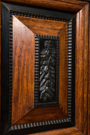 A Dutch partly ebonised wooden four-door cupboard, 19th C.