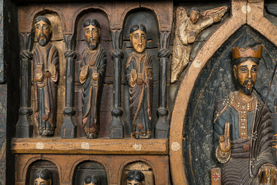 A Spanish polychrome wooden panel depicting Jesus in a medallion surrounded by the twelve apostles after the altar of Sant Pere in Ripoll, 19th C.