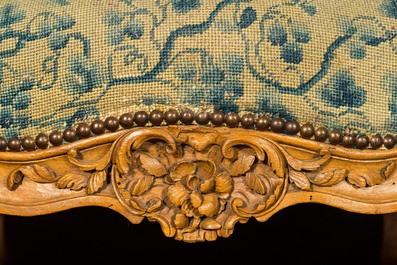 A large French Louis XV beechwooden sofa with embroidered upholstery, 18th C.