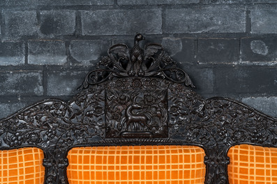 An Anglo-Indian colonial carved wooden sofa with two matching chairs, late 19th C.