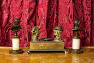 A pair of patinated bronze busts on a pedestal and a bronze ink set with playful heads, 19th C.