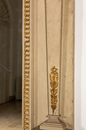 An impressive French Empire-style gray-patinated and gilt wooden mirror console with marble top, 19th C