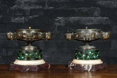 A pair of French silver-plated bronze neoclassical oil lamps on a marble and faux marbre base, 19th C.