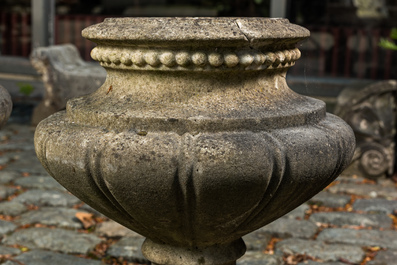 A pair of stone garden vases on square bases, one dated 1873