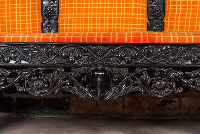 An Anglo-Indian colonial carved wooden sofa with two matching chairs, late 19th C.