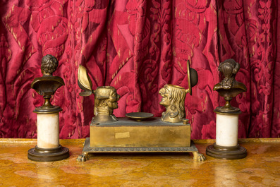 A pair of patinated bronze busts on a pedestal and a bronze ink set with playful heads, 19th C.