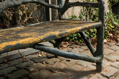 A garden bench in a patinated faux bois structure, 20th C.