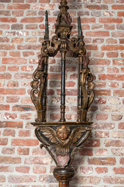 A pair of large polychromed and gilt processional torches with cherub heads, 18th C.