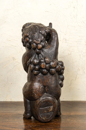 A carved walnut figure of Bacchus on a barrel, 18/19th C.