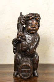 A carved walnut figure of Bacchus on a barrel, 18/19th C.