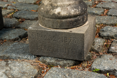 A pair of stone garden vases on square bases, one dated 1873