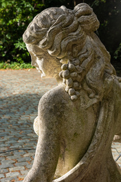 A life size composite stone female allegorical 'autumn' figure with grapes and pomegranates, 20th C.