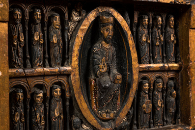 A Spanish polychrome wooden panel depicting Jesus in a medallion surrounded by the twelve apostles after the altar of Sant Pere in Ripoll, 19th C.