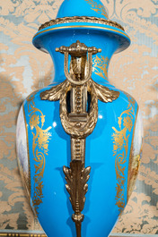 A pair of large S&egrave;vres-style lidded vases in 'Bleu c&eacute;leste' porcelain with gilt bronze mounts, signed Pecchioli, 19/20th C.