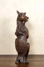 Two oak sculptures of mythical creatures with a shield, 19th C.