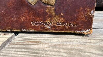 A Spanish rectangular panel of embossed gilt leather wallpaper, signed Meryan, Cordoba, 20th C.