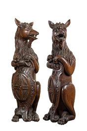 Two oak sculptures of mythical creatures with a shield, 19th C.