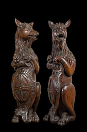 Two oak sculptures of mythical creatures with a shield, 19th C.